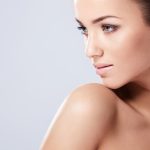 A woman with a well-defined jawline, likely showcasing the results of a cosmetic procedure.
