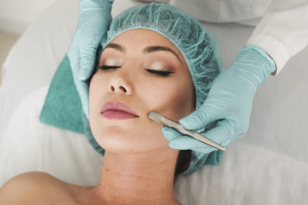 woman doing liposuction on her face, feminine