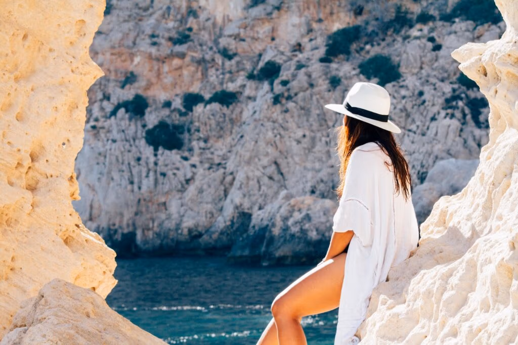 Rear View of Woman Sitting on a rock, The Benefits of Hair Transplant in Antalya for Women