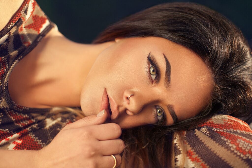 woman wearing red, white, and black aztec top, facial feminization surgery