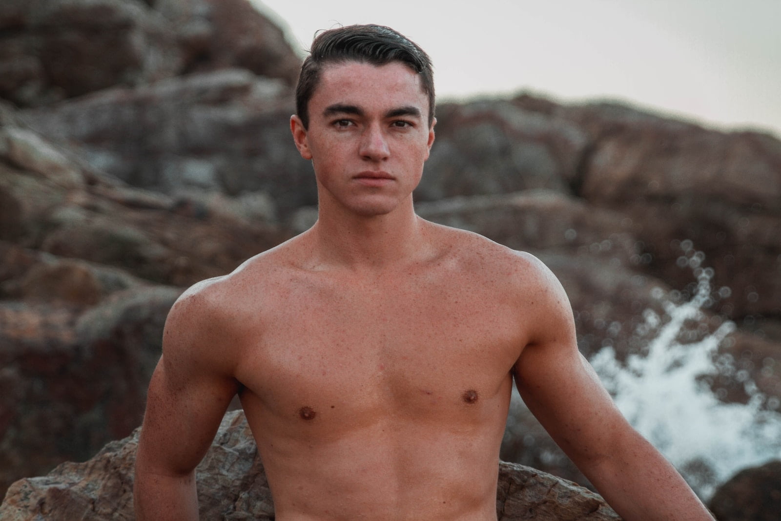 topless man near splashing water