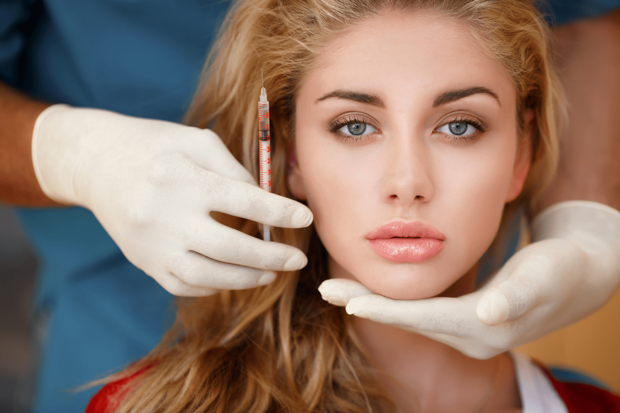 A woman receiving a dermal filler injection from a medical professional.
