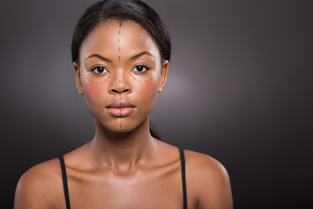 A close-up portrait of a woman with makeup guidelines marked on her face, illustrating contouring techniques.