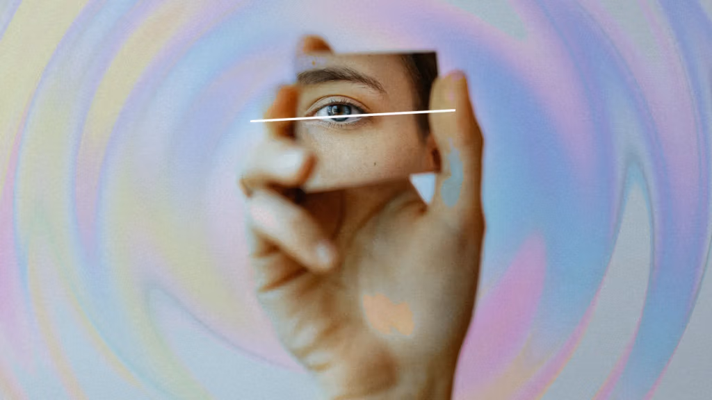 A close-up artistic image of a person's eye with a colorful, swirling background and abstract hand gestures framing the face.