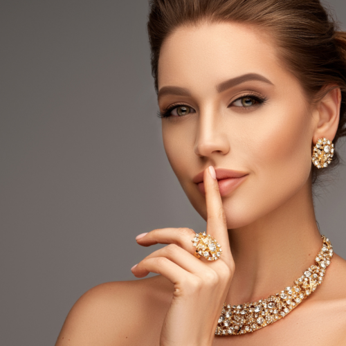 A woman with elegant makeup and jewelry gesturing for silence