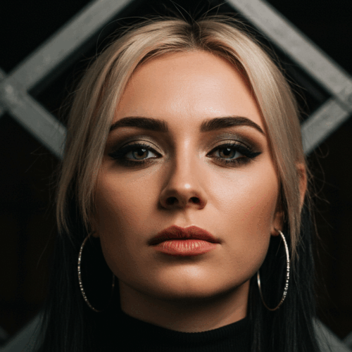 A close-up portrait of a woman with blonde hair and striking makeup, including dark eyeshadow and bold eyeliner, wearing large hoop earrings, set against a dark background with a geometric pattern.