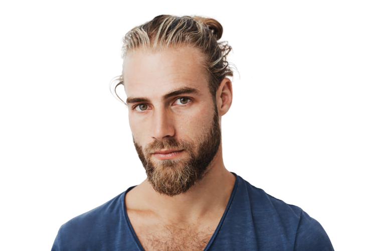 A man with a beard and long hair tied in a bun, wearing a blue shirt, looking straight at the camera.